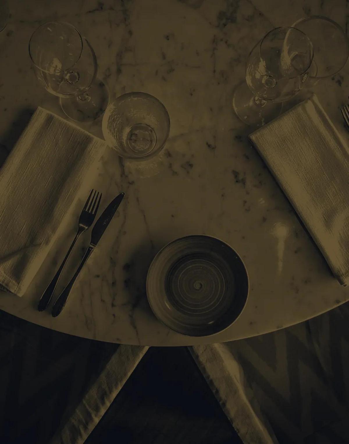 A marble table top under a low lamp